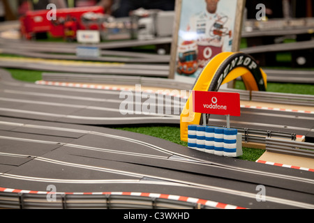 A large toy scalextric track with model cars going round the electric circuit England UK Stock Photo