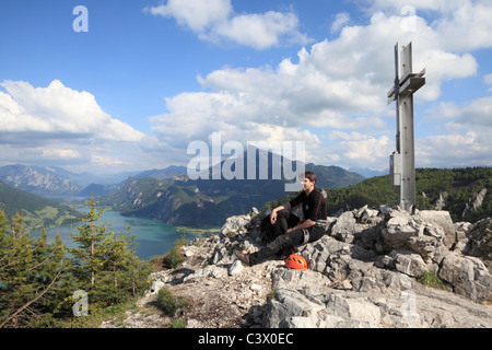 A climber rests on top of the Drachenwand after climbing up the fixed wires Stock Photo