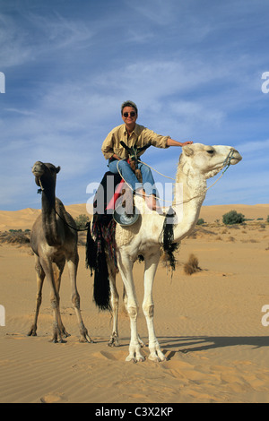 Tourist riding a camel Stock Photo - Alamy