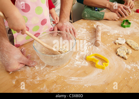 Hands of family cooking together Stock Photo