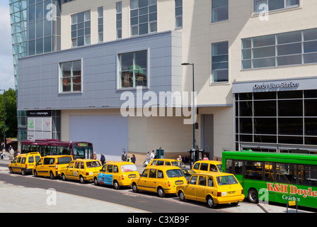 Derby bus station with yellow taxi cabs and buses on a busy day Morledge The Cockpit Derby city centre Derbyshire England GB UK Stock Photo