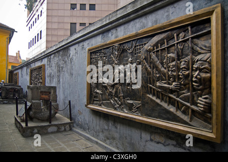 Horizontal view of large brass plaques on the walls of Hoa Lo Prison Museum historically known as the Hanoi Hilton in Hanoi. Stock Photo