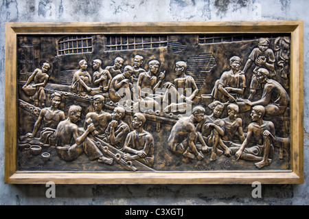 Horizontal view of provoctive brass plaques on the walls of Hoa Lo Prison Museum historically known as the Hanoi Hilton in Hanoi Stock Photo