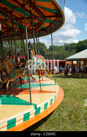 Wooden horses know as 'gallopers' on a traditional fair ground ride at a steam and vintage rally. Stock Photo