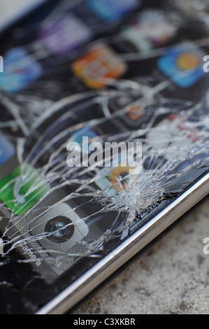 english man with a smashed iphone in the street Stock Photo