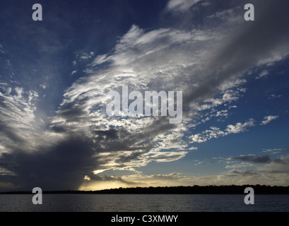 White and Grey clouds brightly back-lit over water.This cloud formation was photographed over Fraser Island-Queensland-Australia Stock Photo