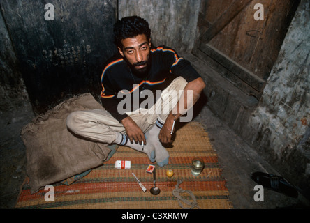 Indian drug addict getting high after injecting himself with heroin. Bombay, India. Stock Photo