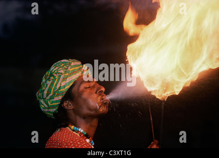 Indian fire eater blows flames during a street performance. New Delhi, India Stock Photo