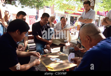 Gulangyu, China. Local chinese men play cards in village square. Stock Photo