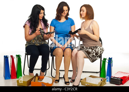 Three woman in a shop choosing shoes,compare different shoes and having conversation Stock Photo