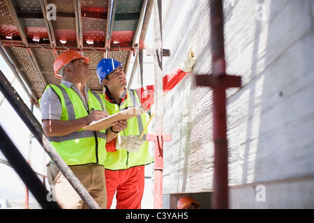 Building workers inspecting a wall Stock Photo