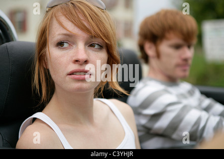 portrait, young couple, driving, convertible, portraits, couple, friendship, looking away, cutout, thoughtful, outside, attracti Stock Photo