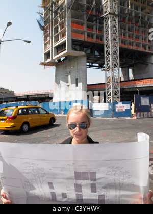Architect with blue prints in the street Stock Photo