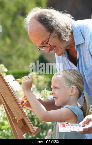 Grandfather and granddaughter painting Stock Photo