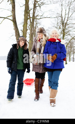 A family out for a walk in the snow