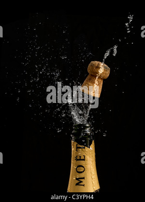 Cork 'popping' on a bottle of Moet & Chandon Champagne. The word Champagne is visible on the cork Stock Photo