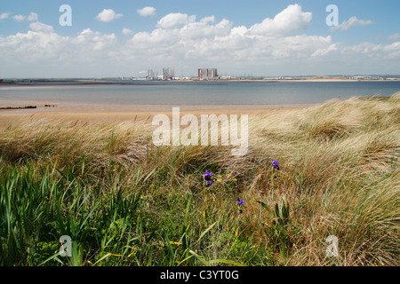 View towards Hartlepool nuclear power station over the Tees estuary from South Gare near Redcar, Cleveland, North East England UK Stock Photo