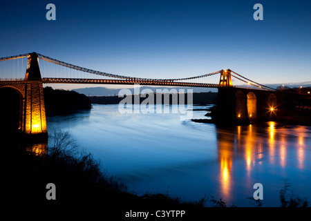 Evening illuminations on the Menai Bridge spanning the Menai Strait, Anglesey, North Wales, UK. Spring (April) 2011. Stock Photo