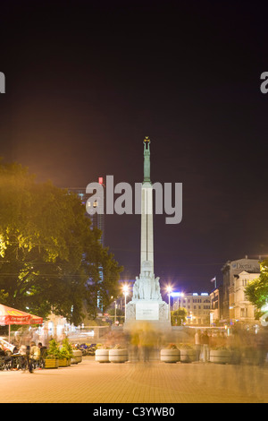 Kalku Street with Freedom Monument, Statue of Liberty, Brivibas piemineklis at night. Riga Latvia Stock Photo