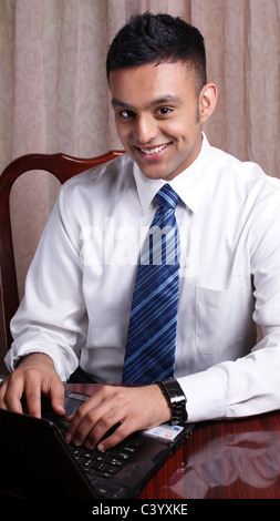 A young business man working on his laptop Stock Photo