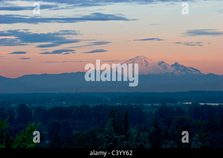 Mount Baker sunset, as seen from Port Coquitlam, BC, Canada. New Golden Ears bridge construction can be seen in the foreground Stock Photo