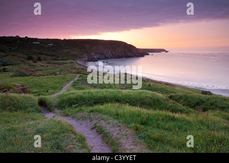 Sunrise on the South West Coast Path at Kennack Sands, Lizard Peninsula, Cornwall, England. Spring (May) 2011. Stock Photo