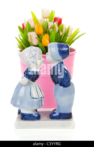 Typical Dutch souvenir in Delft blue and plastic tulips in bucket over white background Stock Photo