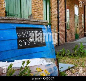 WHITSTABLE, KENT, UK - APRIL 30, 2011:  Old wooden boat with sign for Whitstable Oyster Company Stock Photo