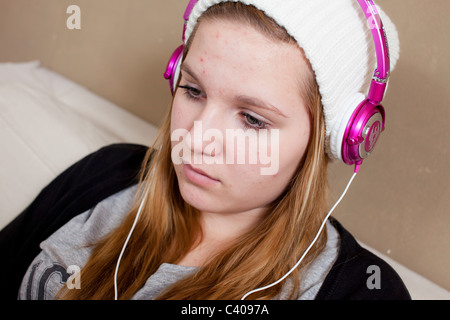 Malmoe, Sweden - 25 November, 2010: Young teenage girl is deep in her own thoughts while listening to music in headphones Stock Photo