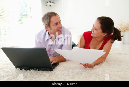 Couple joke when sorting out bills Stock Photo