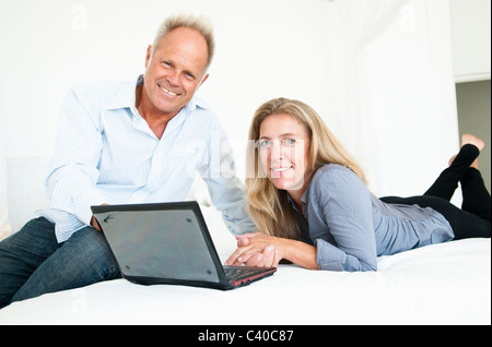 Middle aged couple with laptop Stock Photo