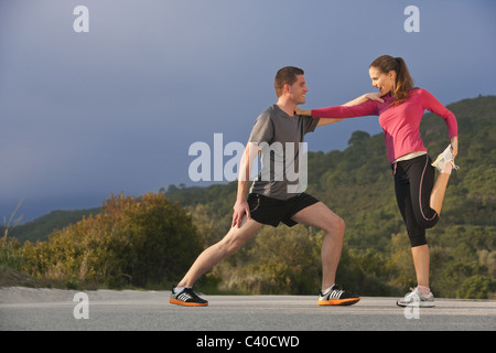 Young athletic couple stretching Stock Photo