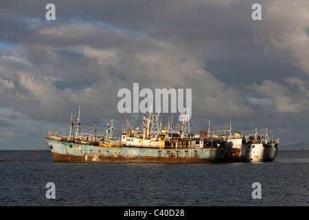 Cargo Boats laying at anchor, Beqa Lagoon, Viti Levu, Fiji Stock Photo