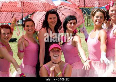 2010 Glastonbury Festival of Contemporary Performing Arts festival girls troupe pink dresses umbrellas dance dancers act Stock Photo