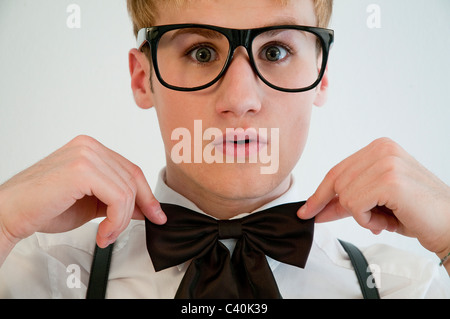 Young man wearing spectacles and bow tie. Close view. Stock Photo