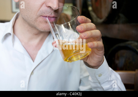 Man drinking a glass of cider. Close view. Asturias, Spain. Stock Photo
