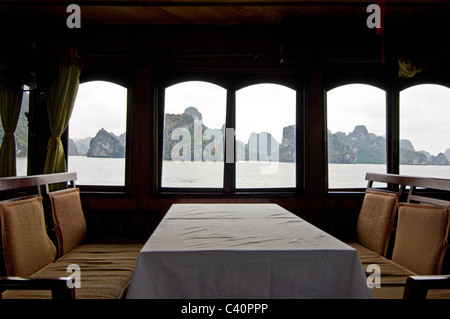 Horizontal view of the limestone karsts (rocks) in Halong Bay from inside a traditional wooden junk used for tour guides. Stock Photo