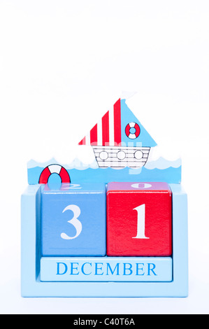 A wooden calendar showing the date of December the 31st ( New Years Eve ) on a white background Stock Photo