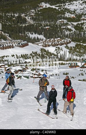 Skiers and a snowboarder at Big Sky Montana, one of North America's biggest ski resorts. Montana, United States, North America Stock Photo