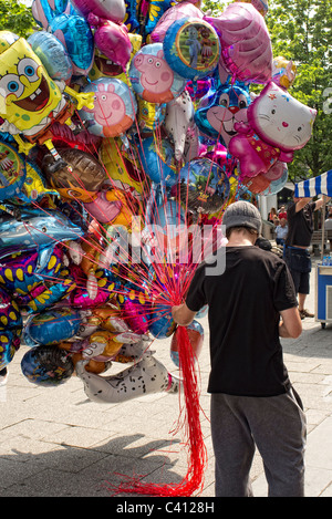 man selling balloons in the street Stock Photo