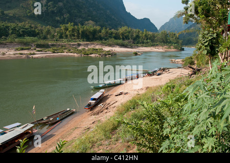 River boats moored by the sandy riverbank in North East Laos Stock Photo