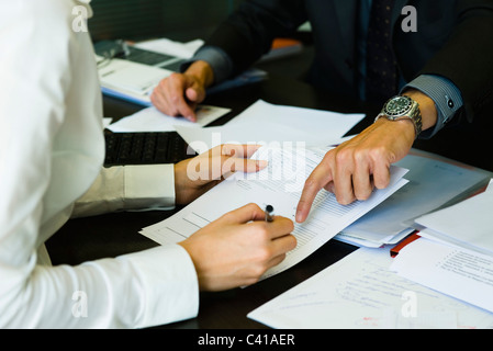 Person signing paperwork, cropped Stock Photo