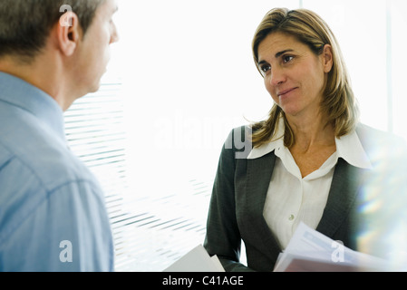 Businesswoman talking to colleague Stock Photo