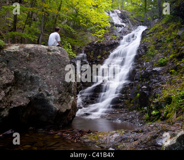 Overall Run waterfall is the highest waterfall in Virginia if its sections are taken into account. Hiker overlooking the falls Stock Photo