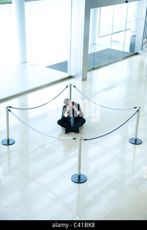 Businessman sitting on the floor isolated on white Stock Photo - Alamy