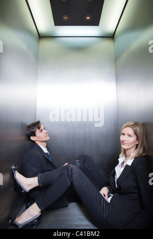 Professionals stuck in elevator together Stock Photo