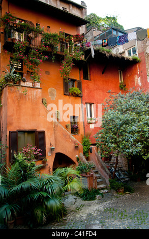Traditional old italian house painted in ochre- Via Del Pellegrino, Campo di Fiore, Rome Italy Stock Photo