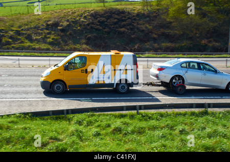 AA van on the M62 (towing a silver BMW saloon car). Stock Photo