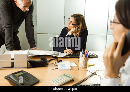 Colleagues working together in office Stock Photo