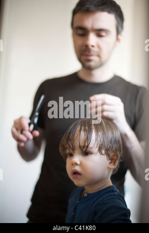 Toddler boy having his hair cut Stock Photo